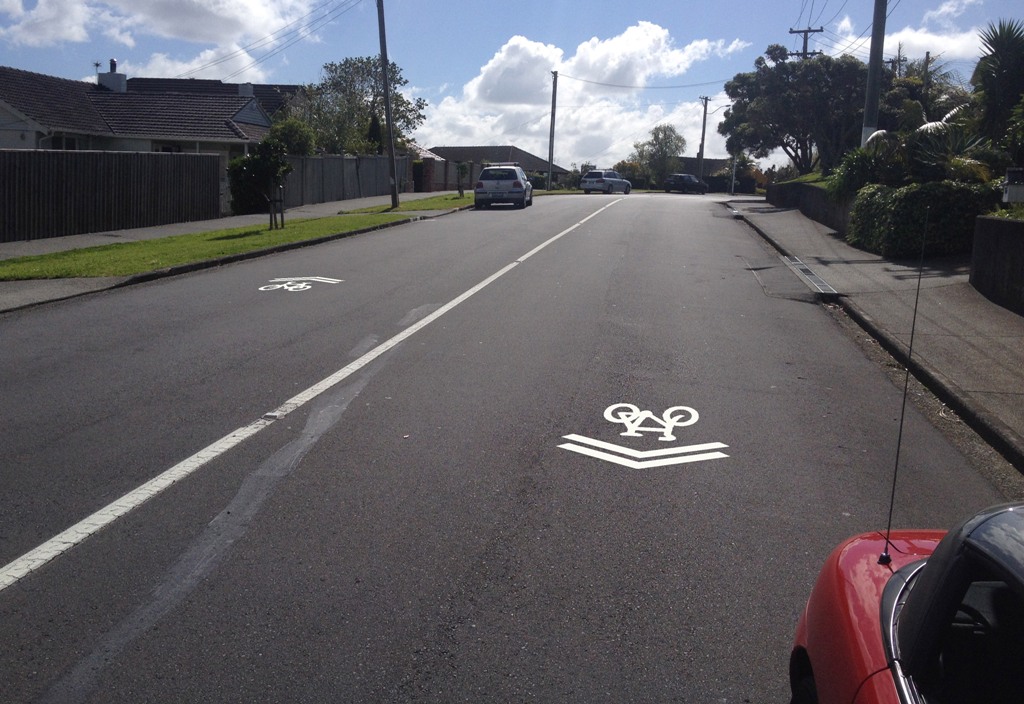 Properly located sharrows will steer bikes out past parked cars (c/ Akld Transport)